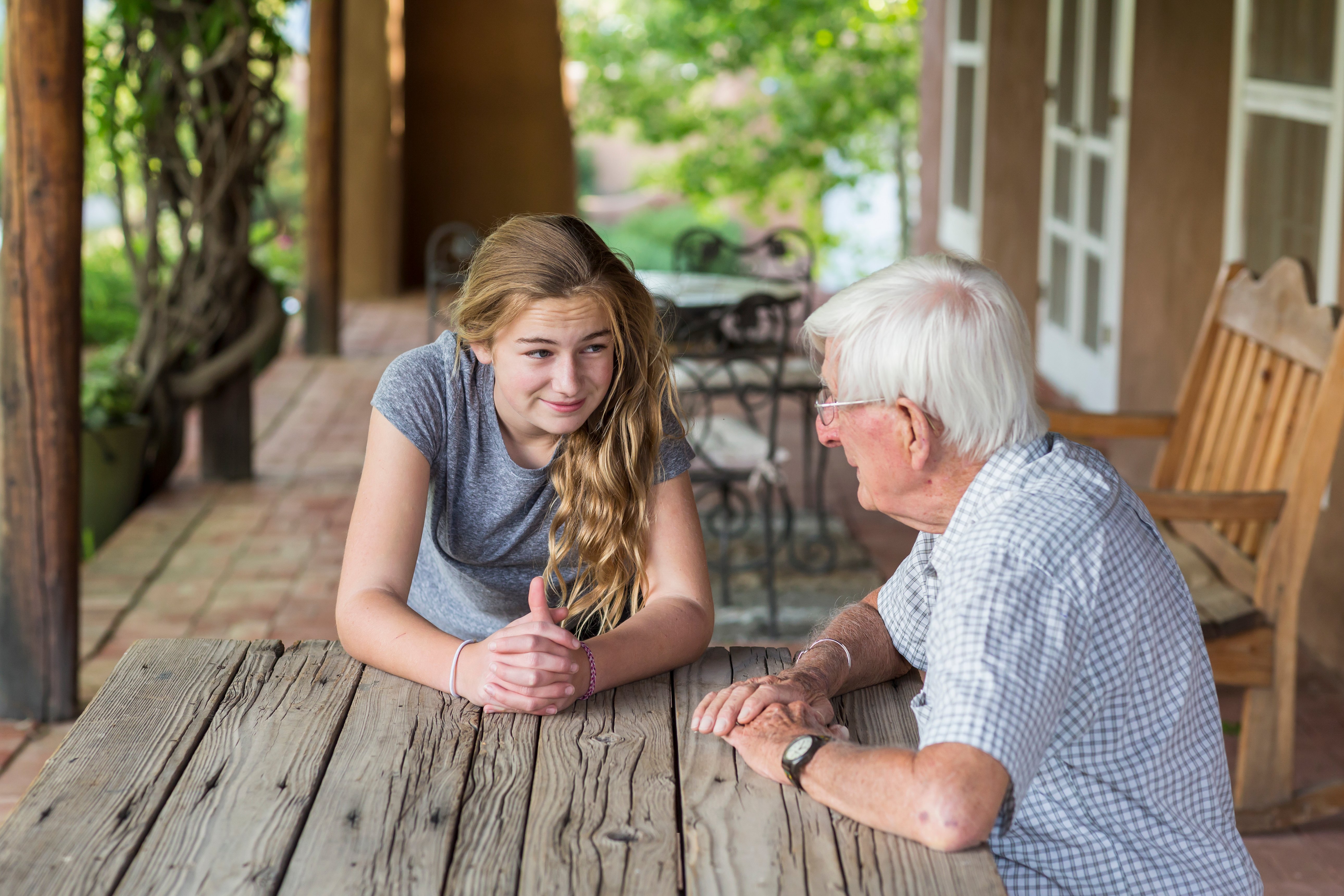 teenage-girl-having-a-conversation-with-her-grandfather