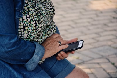 close-up-of-senior-womens-hand-using-smartphone