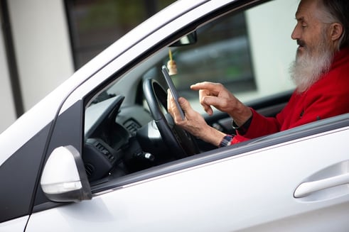 senior-man-driving-and-texting