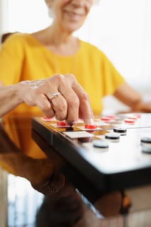 grandma-playing-checkers-board-game-in-hospice-PD2UEZW