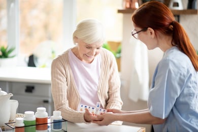 caregiver-helping-a-senior-woman-with-medication