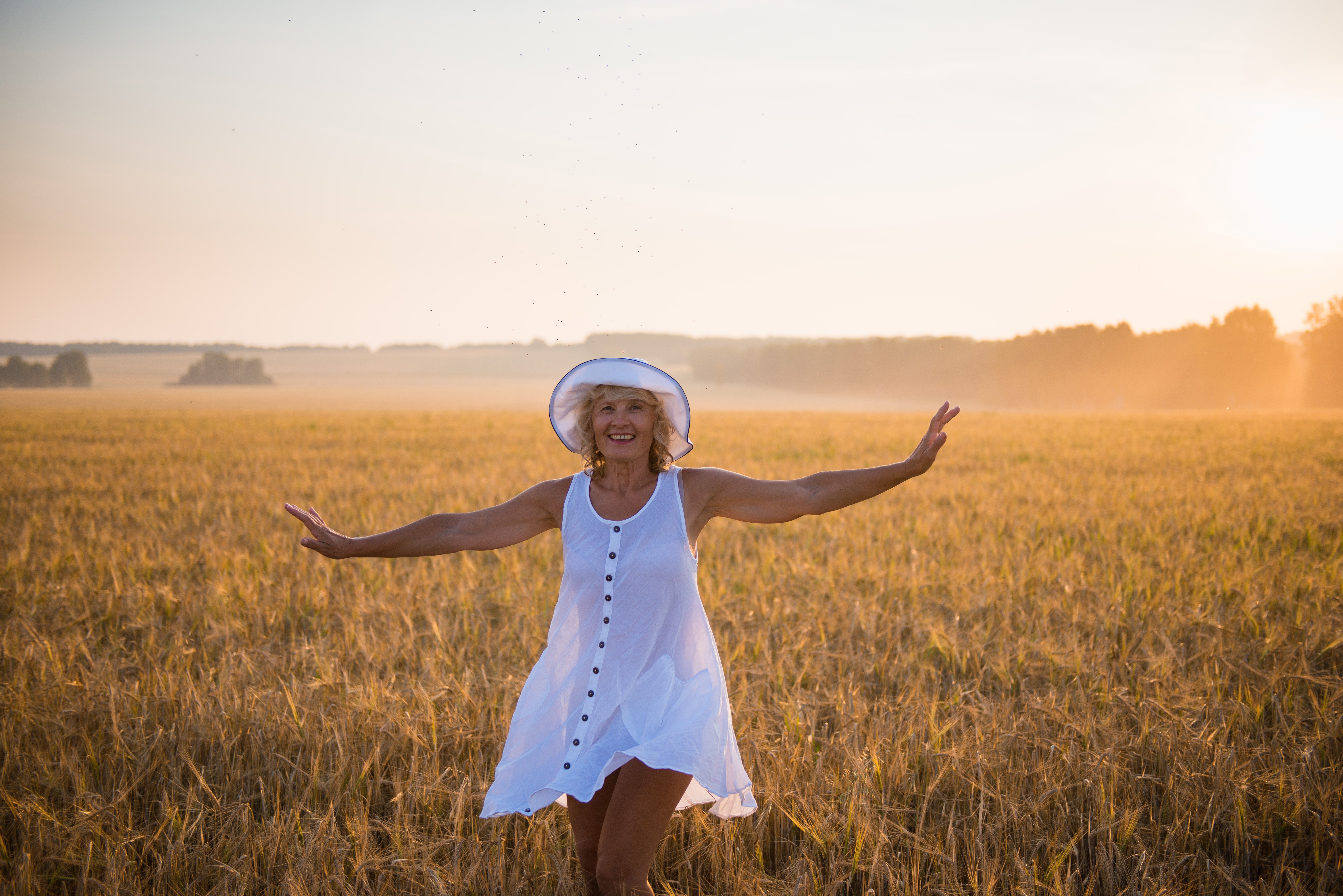 senior-woman-frolicking-through-wheat-field