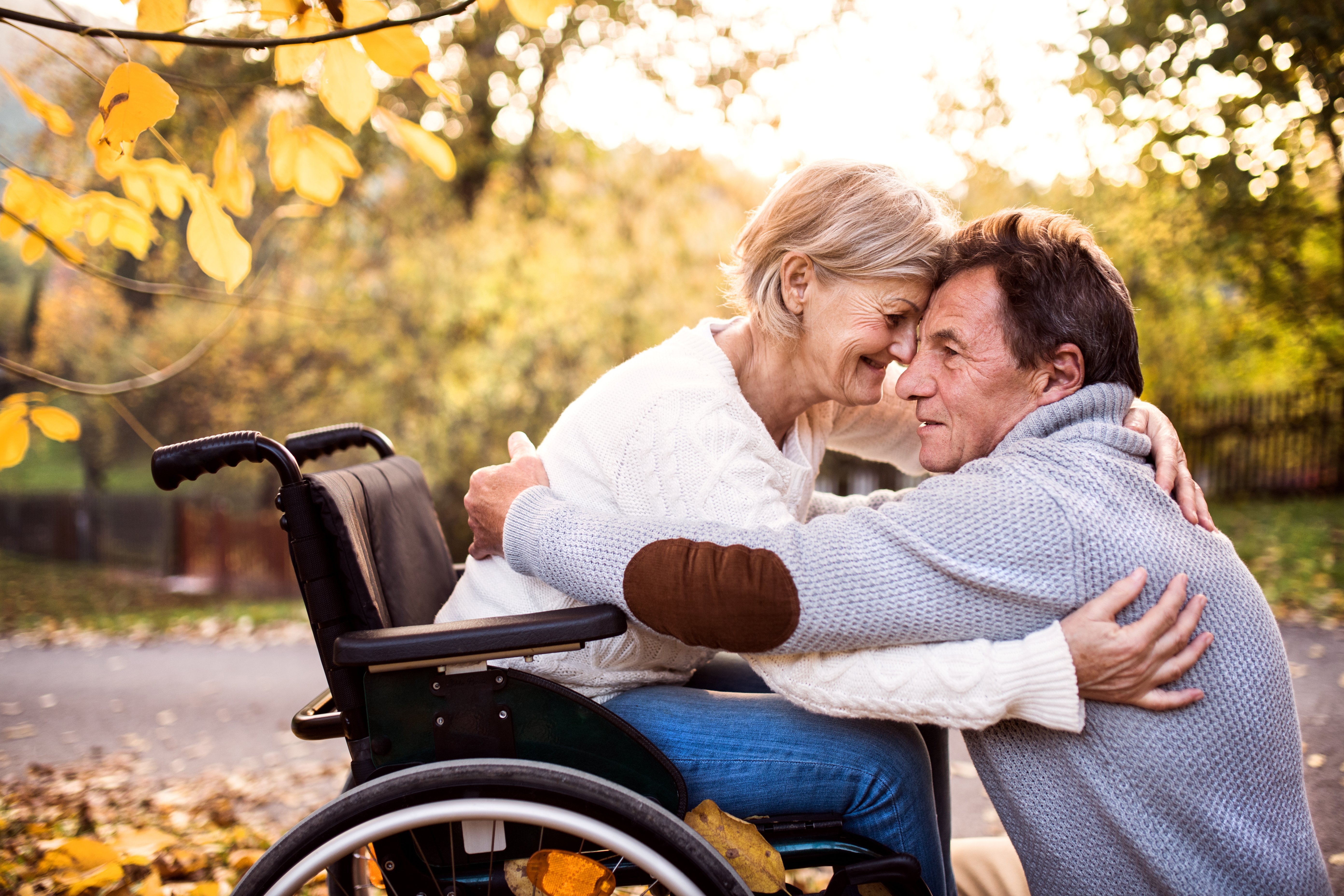 senior-man-embracing-senior-woman-in-wheelchair