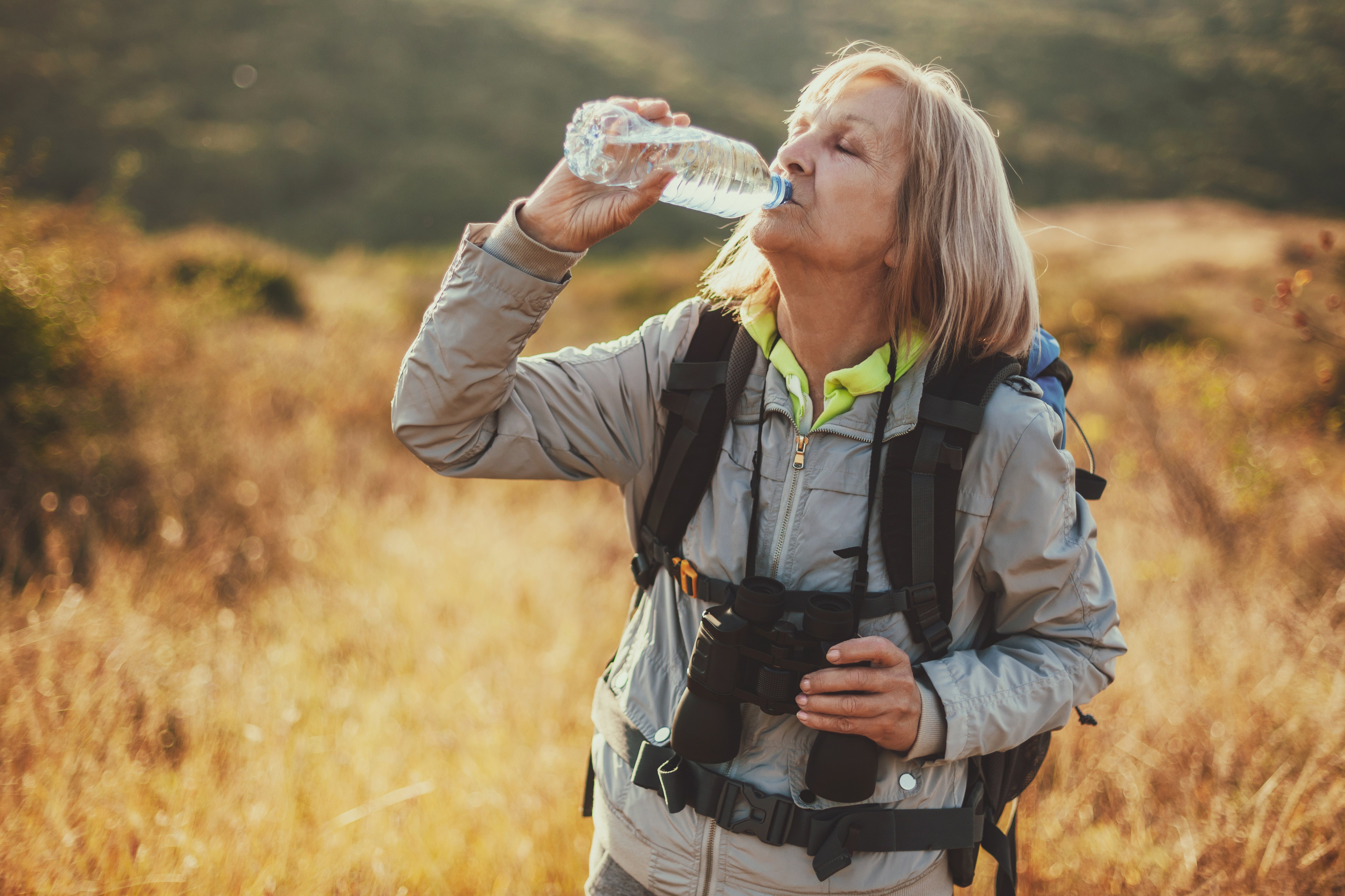 senior-woman-hiking-drinking-waterbottle