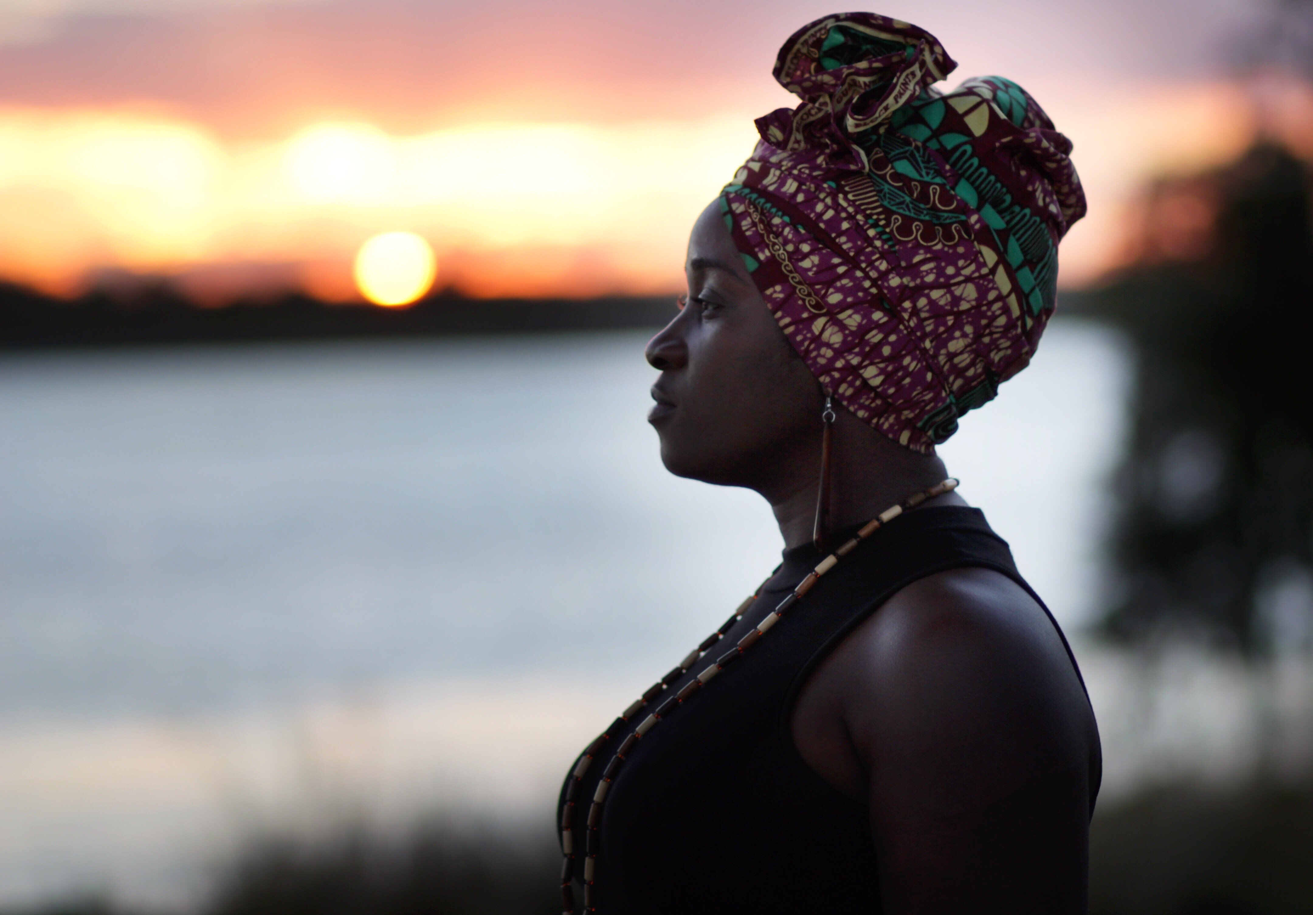 woman-with-headwrap-staring-off-into-sunset