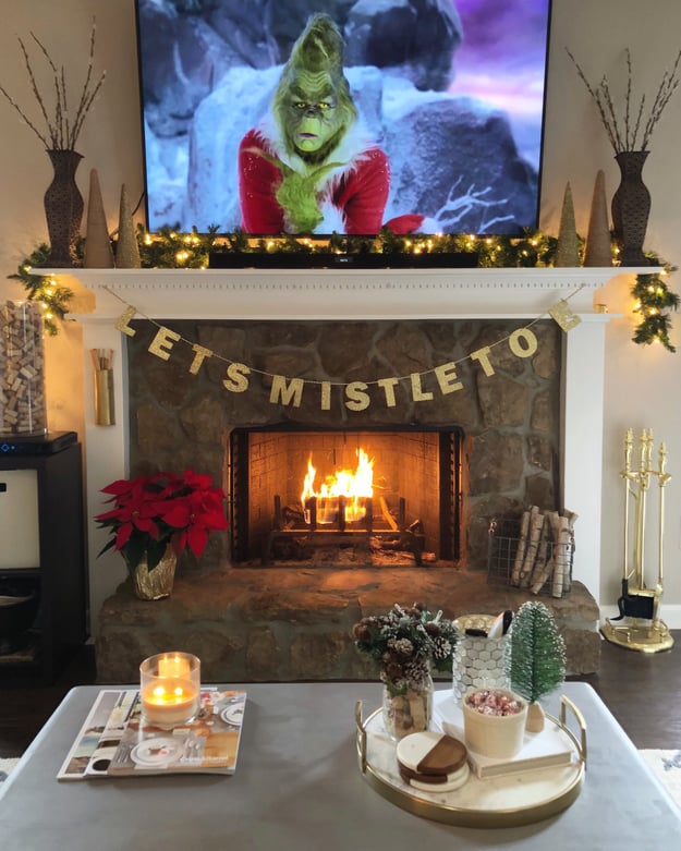 cozy-holiday-scene-with-fireplace-and-holiday-movie-playing