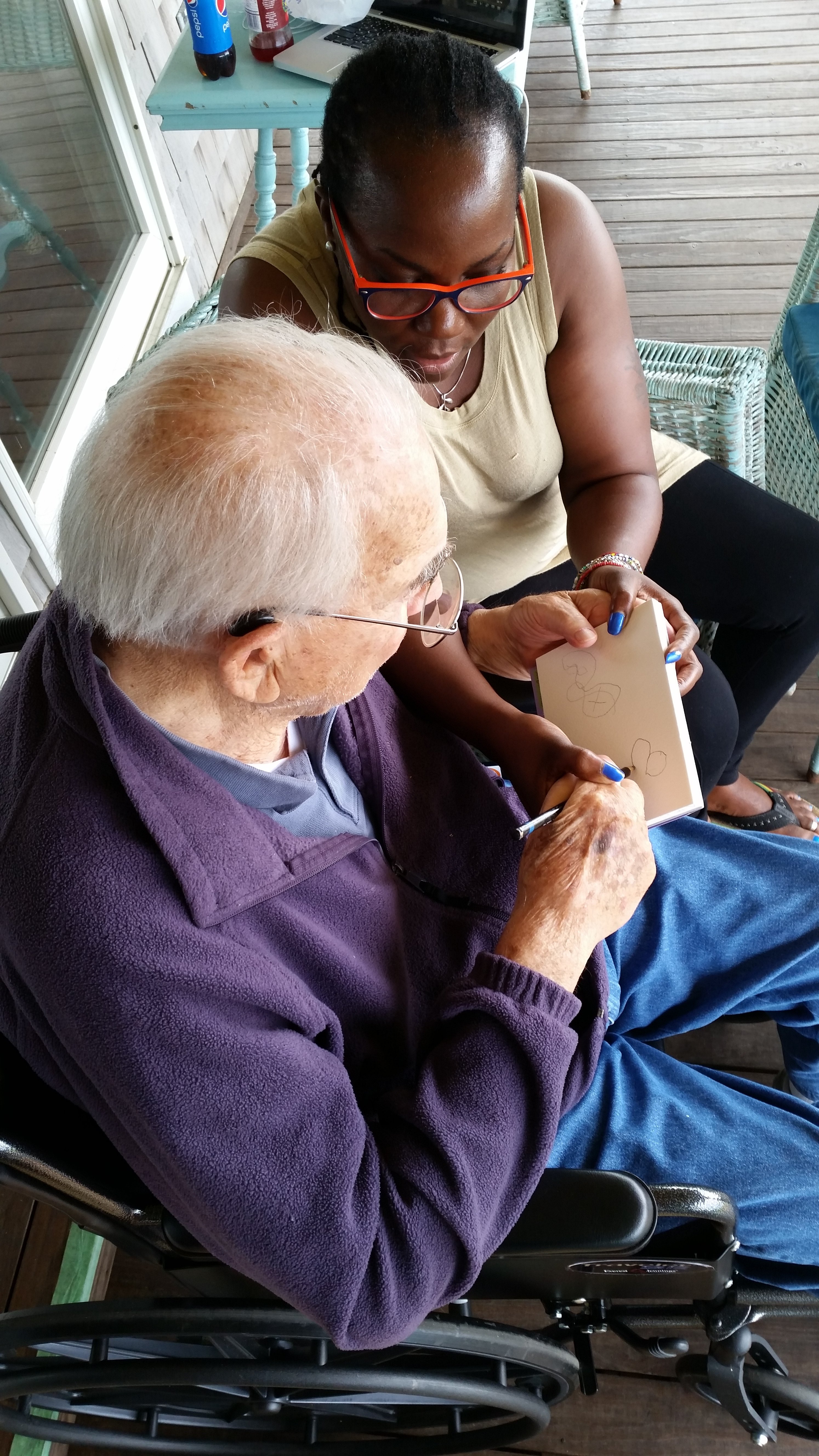 woman-helping-old-man-in-a-wheelchair-to-draw